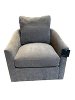 Gray armchair with curved back and over stuffed cushions on a white background 