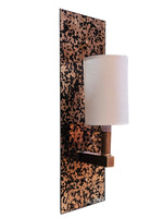 A modern wall-mounted sconce with a rectangular backplate and cylindrical shade, featuring a copper and black speckled pattern on the backplate and a white fabric drum shade.