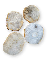 Four natural agate slice coasters with textured crystalline patterns, displayed on a clean white background.