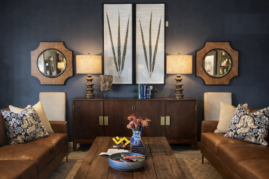 Living room with leather sofas, a walnut sideboard and round mirrors